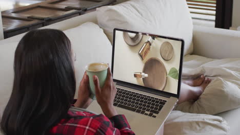 Biracial-woman-using-laptop-at-home-for-online-shopping,-slow-motion