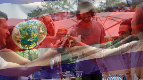 Composite-video-of-waving-costa-rica-flag-over-diverse-friends-toasting-drinks-having-lunch-in-park