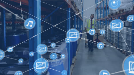 Animation-of-network-of-connections-with-icons-over-biracial-man-working-in-warehouse