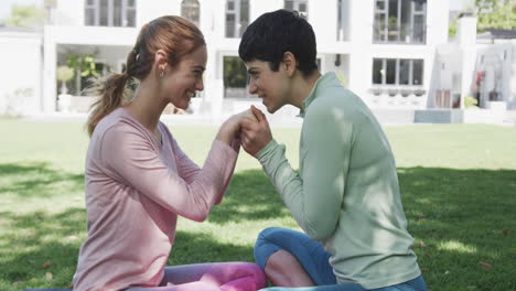 Happy-caucasian-lesbian-couple-showing-tenderness-each-other-in-sunny-garden,-slow-motion