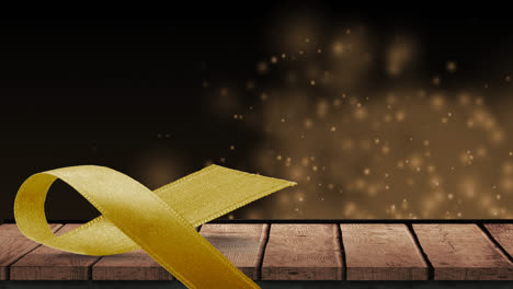 Animation-of-yellow-ribbon-over-wooden-surface-and-spots-in-background
