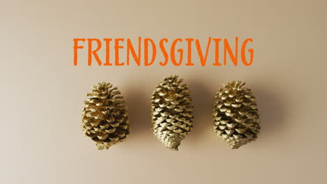 Animation-of-friendsgiving-text-and-pine-cones-on-brown-background