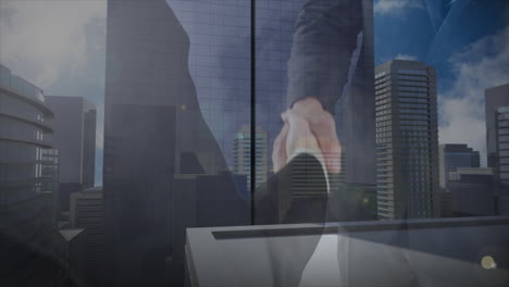 Animation-of-mid-section-of-businessman-and-businesswoman-shaking-hands-against-tall-buildings