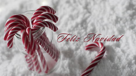 Feliz-Navidad-Text-Mit-Weihnachten-Zuckerstangen-Auf-Schnee-Hintergrund
