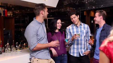 Attractive-friends-talking-and-drinking-at-the-bar