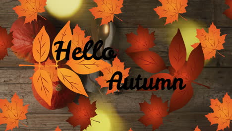 Animation-of-hellow-autumn-text-over-cutlery-and-autumn-leaves-over-wooden-background