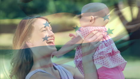 Composite-video-of-waving-honduras-flag-over-caucasian-mother-playing-with-her-daughter-in-the-park
