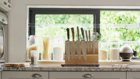 Empty-house-interior-of-kitchen-with-knifes-in-row-on-table