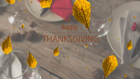 Animation-of-happy-thanksgiving-over-autumn-leaves-and-place-setting-on-wooden-background