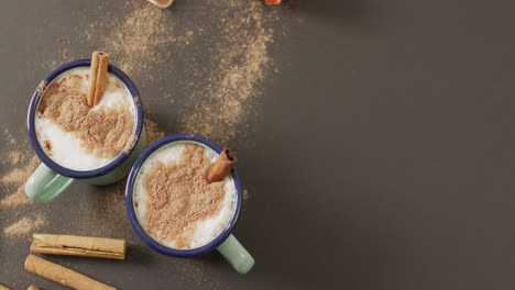 Video-of-cups-of-hot-chocolate-with-cinnamon-over-grey-background