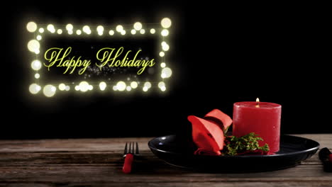 Animation-of-happy-holidays-text-with-plate-and-candle-on-black-background