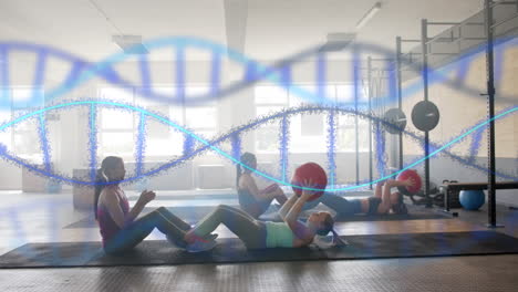 Animation-of-dna-strands-over-diverse-women-cross-training-in-pairs-with-medicine-balls-at-gym