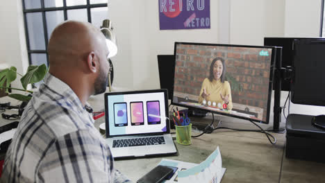 African-american-businessman-on-video-call-with-caucasian-female-colleague-on-screen