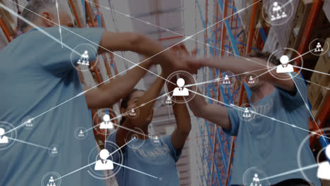 Animation-of-network-of-connections-with-icons-over-diverse-volunteers-working-in-warehouse