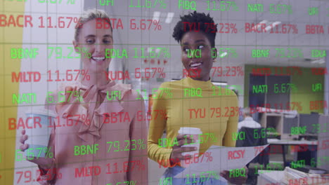 Animation-of-stock-market-data-processing-over-two-diverse-women-discussing-in-office-corridor