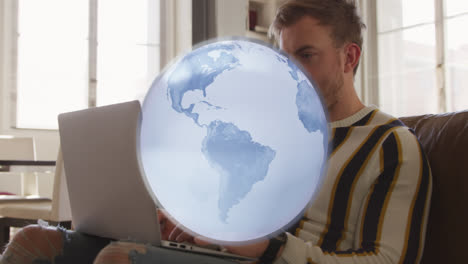 Animation-of-globe-spinning-over-caucasian-man-using-laptop