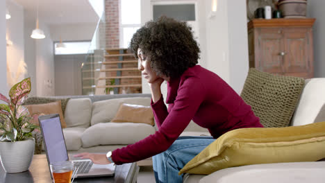Mujer-Birracial-Feliz-Usando-Laptop-En-Casa,-Cámara-Lenta