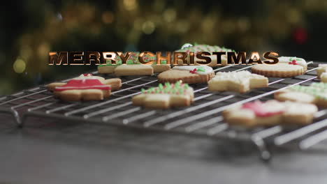 Merry-christmas-text-in-gold-over-decorated-christmas-cookies