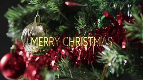 Merry-christmas-text-in-yellow-over-decorations-on-christmas-tree