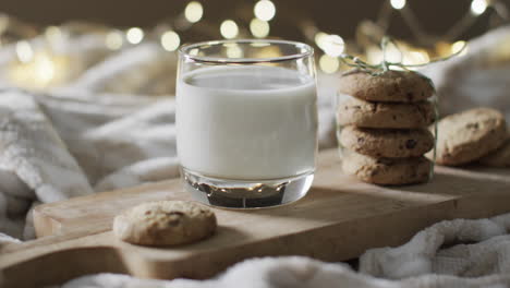 Video-of-christma-cookies,-glass-of-miljk-and-copy-space-on-white-background