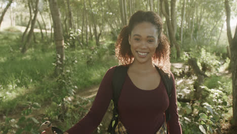 Portrait-of-happy-african-american-woman-hiking-in-forest,-slow-motion