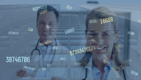 Animation-of-numbers-processing-over-caucasian-female-and-male-doctors-smiling