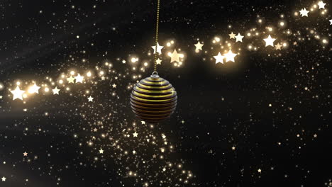 Swinging-black-and-gold-christmas-bauble-over-glittering-shooting-star-on-dark-background