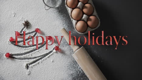 Happy-holidays-text-in-red-over-christmas-tree-drawn-in-flour,-eggs-and-rolling-pin
