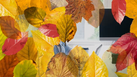 Animation-of-autumn-leaves-over-caucasian-businesswoman-using-laptop