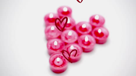 Animation-of-multiple-red-hearts-over-pink-candles