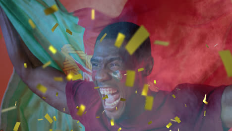 Animation-of-gold-confetti-over-cheering-african-american-male-sports-fan-waving-flag-of-portugal