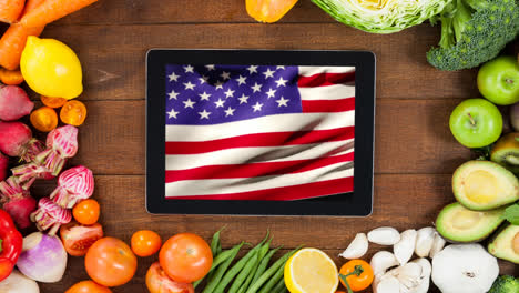 Animation-of-fresh-fruit-and-vegetables-and-flag-of-united-states-of-america-on-tablet