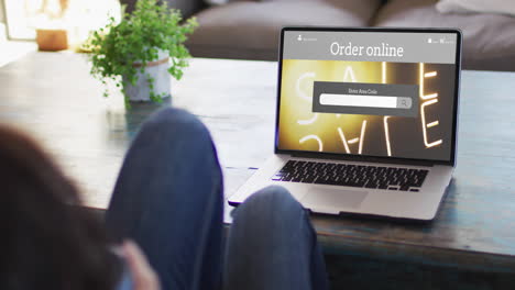 Knees-of-woman-at-table-using-laptop,-online-shopping-during-sale,-slow-motion