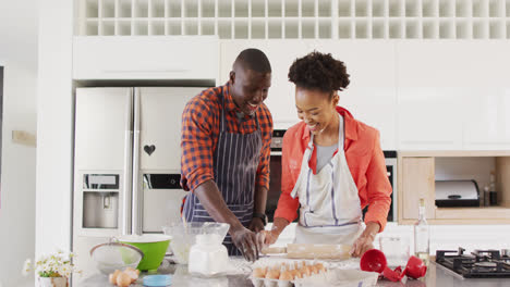 Video-of-happy-african-american-couple-baking-together-and-having-fun-with-flour