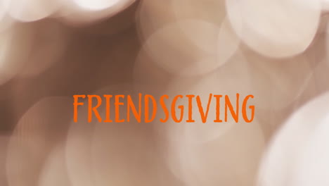 Animation-of-friendsgiving-text-over-spot-lights-brown-background