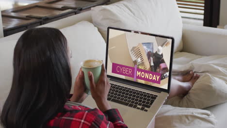 Biracial-woman-on-couch-using-laptop-for-online-shopping,-slow-motion
