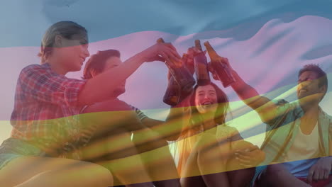 Composite-video-of-waving-germany-flag-against-two-diverse-couples-toasting-beers-outdoors
