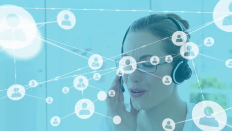 Animation-of-network-of-profile-icons-against-caucasian-woman-talking-on-phone-headset-at-office