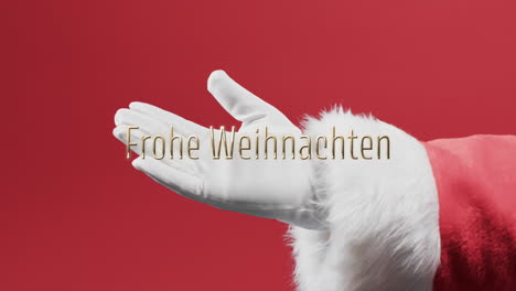 Frohe-weihnachten-text-over-hand-of-father-christmas-outstretched-on-red-background