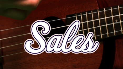 Animation-of-sales-text-banner-against-close-up-of-hand-playing-a-guitar