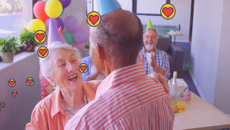 Animation-of-heart-icons-over-diverse-senior-friends-dancing