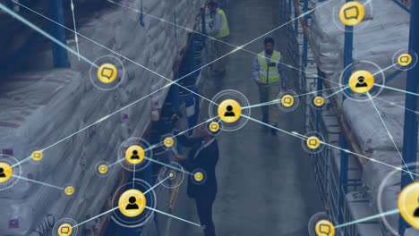 Animation-of-network-of-digital-icons-over-overhead-view-of-asian-male-worker-walking-at-warehouse