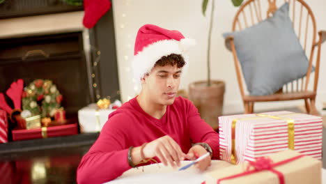 Biracial-man-wrapping-christmas-present-in-decorative-paper,-slow-motion
