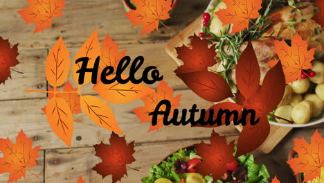 Animation-of-hello-autumn-text-over-dinner-and-autumn-leaves-over-wooden-background