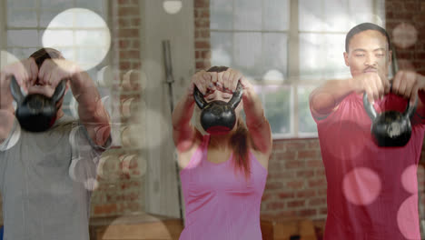 Animation-of-lens-flares-over-multiracial-friends-exercising-with-kettlebells-in-gym