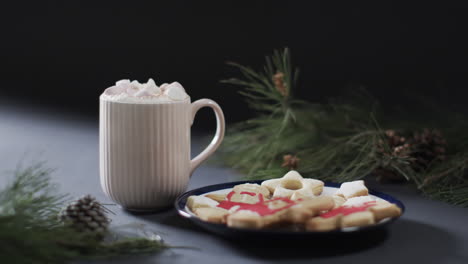 Video-of-christma-cookies,-mug-of-chocolate-and-copy-space-on-black-background