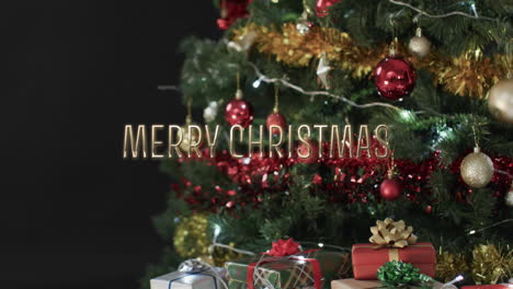 Merry-christmas-text-over-decorated-christmas-tree-and-gifts-on-black-background