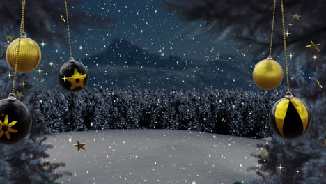 Swinging-black-and-gold-christmas-baubles-over-falling-snow-and-trees-in-night-landscape