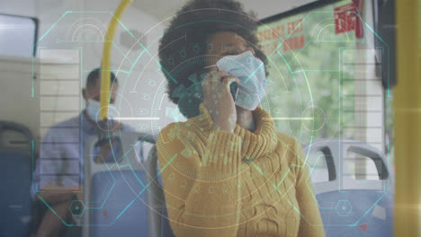 Animation-of-data-processing-over-african-american-woman-with-face-mask-using-smartphone