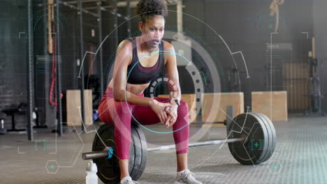 Animation-of-scanner-processing-data-over-biracial-woman-sitting-on-barbells-after-training-at-gym
